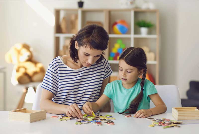 teacher tutoring girl